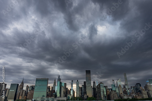 Dark and Creepy Midtown Manhattan Skyline during a Sunset with Large Ominous Clouds in New York City