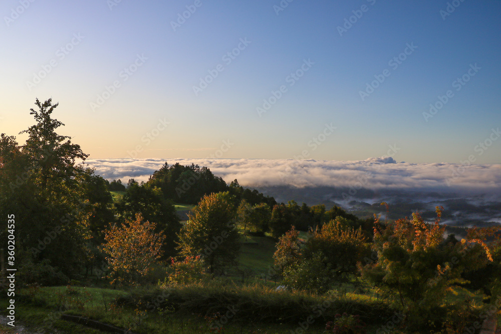 View of a foggy autumn morning in the mountains.