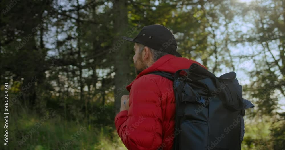 Modern urban nomad travel blogger or adventurer walk through forest. Hiking and camping with minimal gear or location searching for photoshoot. Outdoors camper lifestyle vibes Modern urban nomad travel blogger or adventurer walk through forest. Hiking and camping with minimal gear or location searching for photoshoot. Outdoors camper lifestyle vibes