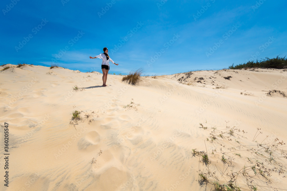 Happy woman on White sand dunes in Vietnam Happy woman on White sand dunes in Vietnam