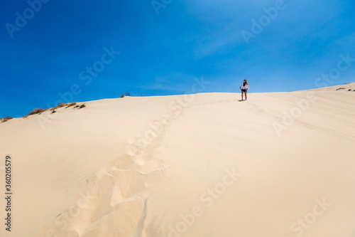 Happy woman on White sand dunes in Vietnam