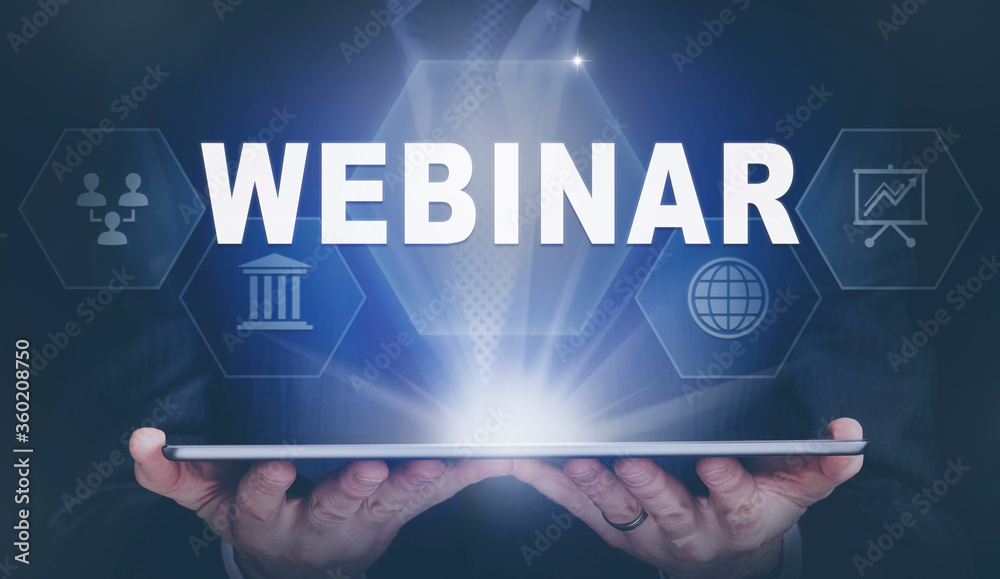 Fototapeta premium Businessman holding a computer tablet display projecting a Webinar concept.