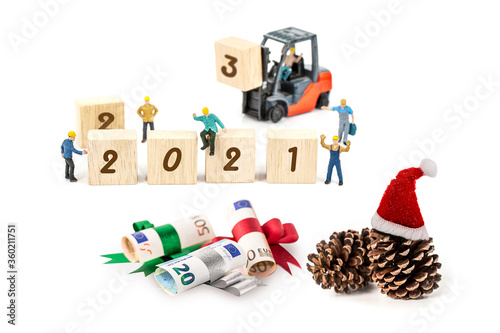 miniature worker team building standing front of forklift machine with 2021 number on wooden block on white background decoration to Happy new year 2021 concept.