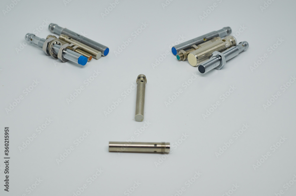 Many Inductive proximity sensor or proximity switch on a white background. Many Inductive proximity sensor or proximity switch on a white background.