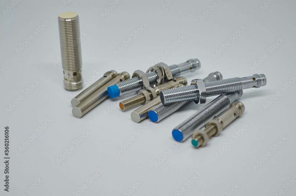 Many Inductive proximity sensor or proximity switch on a white background. Many Inductive proximity sensor or proximity switch on a white background.
