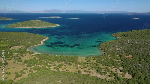 Aerial drone video of beautiful paradise island complex in gulf of Petalion that form a blue lagoon in South Evia island near Marmari, Greece photo