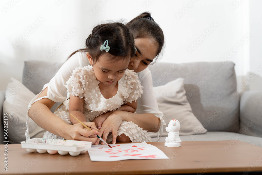 Happy family. Mother and daughter together draw and paint Happy family. Mother and daughter together draw and paint