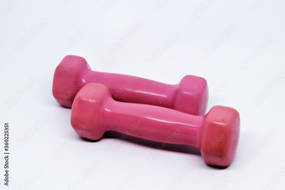 Two pink dumbbells isolated on white background
Two pink dumbbells isolated on white background