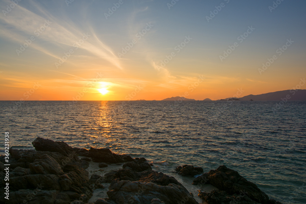 Beautiful sunset with sky over calm sea in tropical lipe island ,satun Thailand