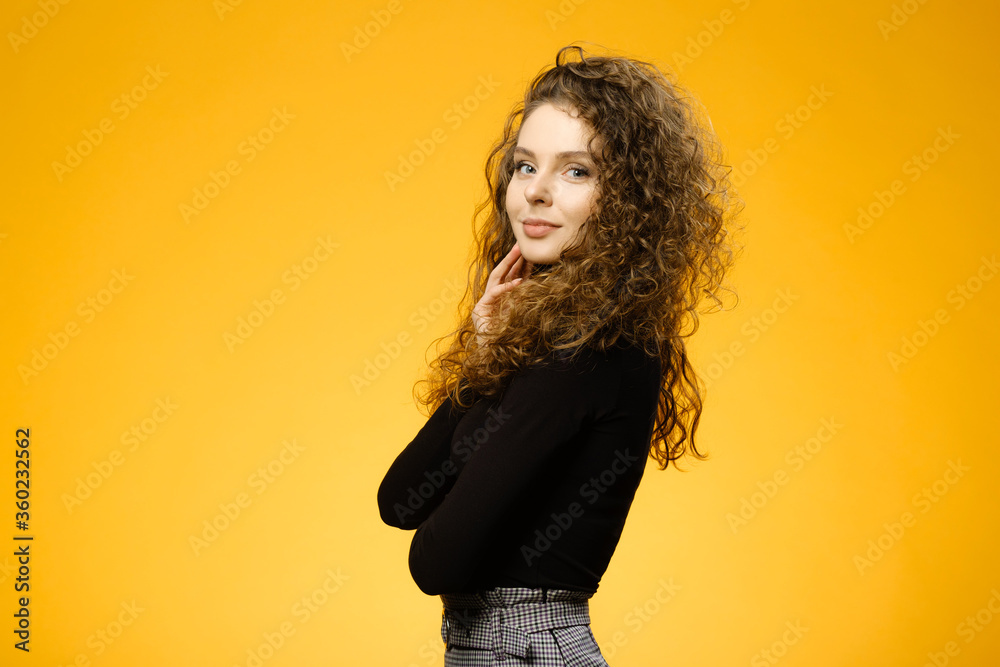 Pretty girl with curly hair on yellow background Pretty girl with curly hair on yellow background
