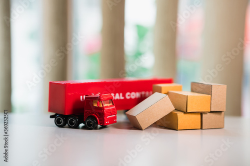 Closeup red universal container truck with carton boxes using for logistics and business concept