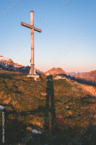 Sunrise on a mountain peak with a long human shadow, Switzerland, Lauterbrunnen