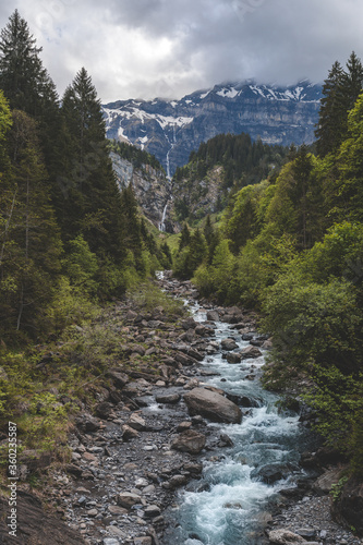 Mountain valley in Switzerland with waterfalls and mountain stream