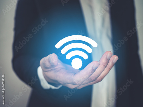 Business man holding WiFi icon, in concept of business network, business online