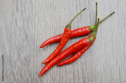Red hot chili isolated on wooden background