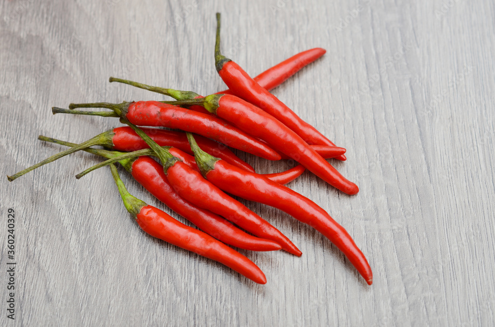 Hot red chili or chilli pepper on wooden