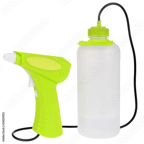 Plastic green bottle with a gun spray on white background
