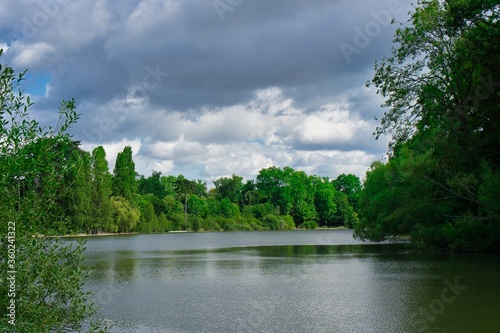 Heavy sky on a lake within the wood