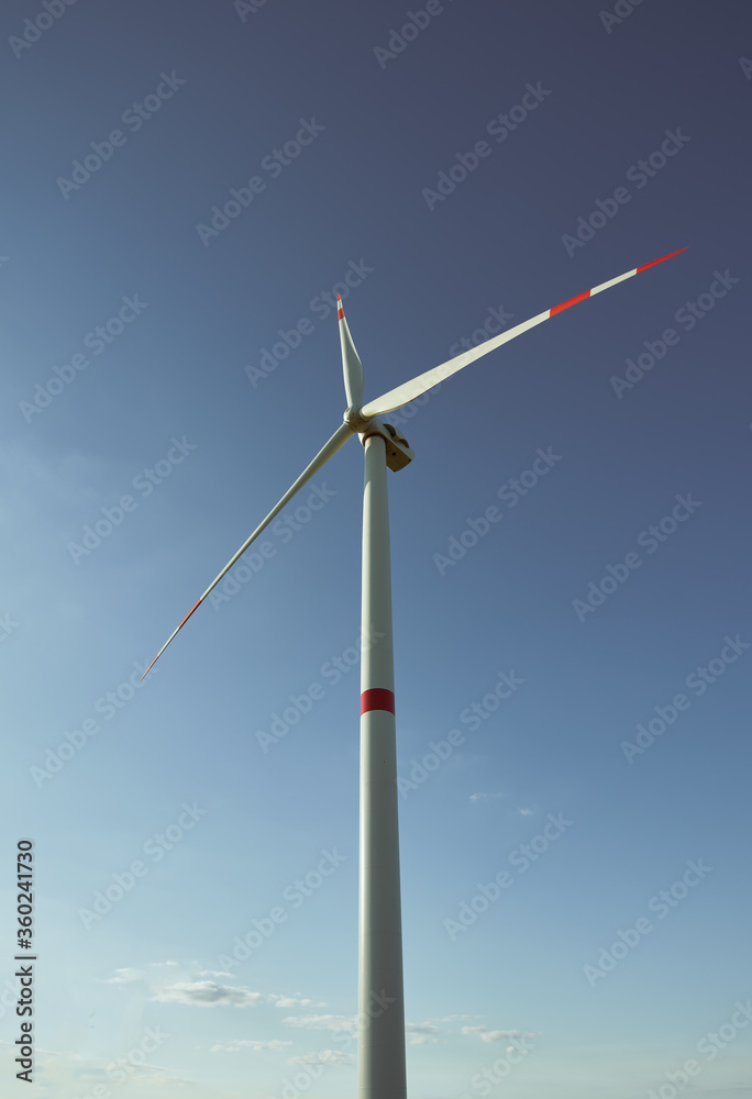 Wind turbine renewable energy source summer landscape with blue sky in natural landscapes Wind turbine renewable energy source summer landscape with blue sky in natural landscapes