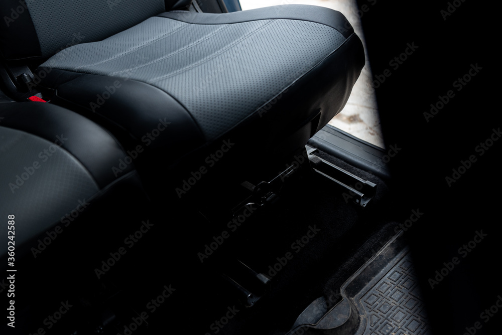 Rails under the seats for adjusting the car seat. Stock Photo Adobe Stock