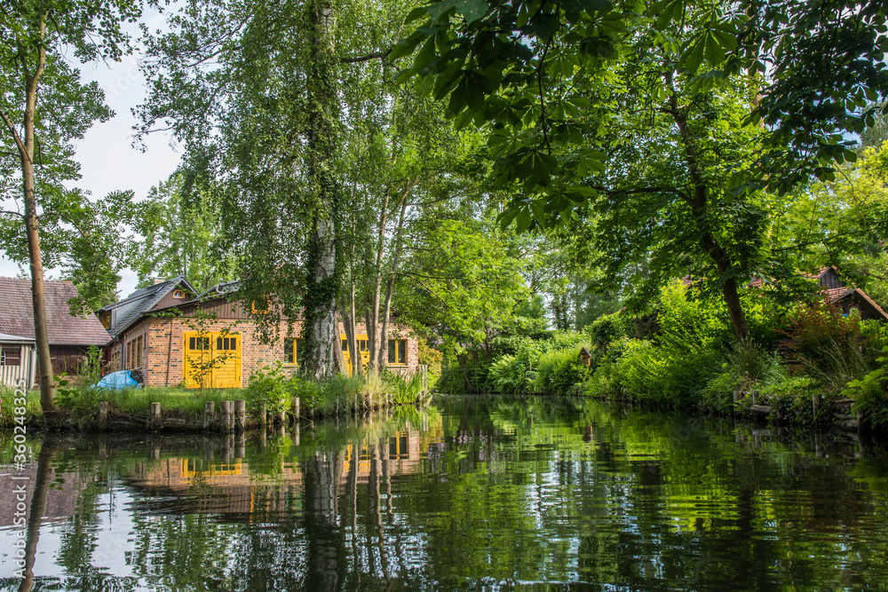 Houses at the water canal in biosphere reserve Spree forest (Spreewald) in the state of Brandenburg, Germany. Houses at the water canal in biosphere reserve Spree forest (Spreewald) in the state of Brandenburg, Germany.