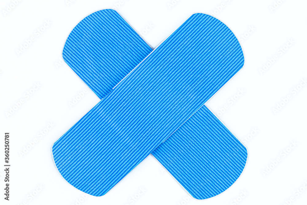Blue wound patches detectable in a metal detector, arranged in the shape of a cross, isolated on a white background with a clipping path. Blue wound patches detectable in a metal detector, arranged in the shape of a cross, isolated on a white background with a clipping path.
