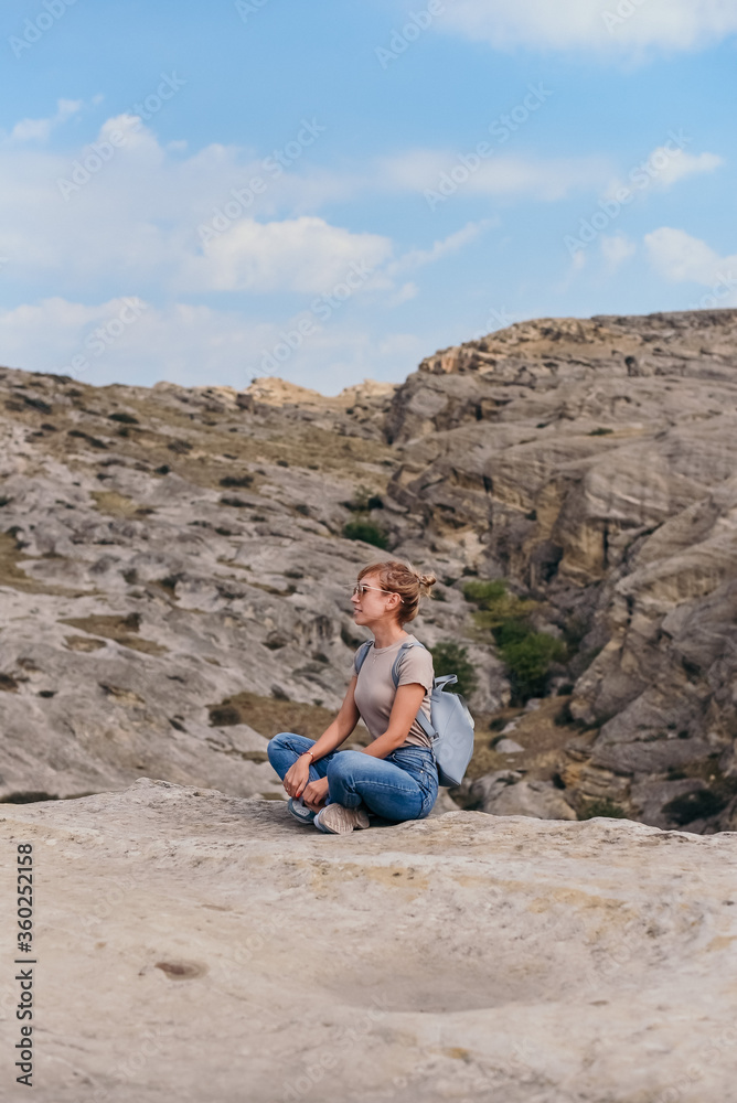 Fototapeta premium Young beautiful women on a camping trip, young woman hiking, woman hiking on a background of mountains