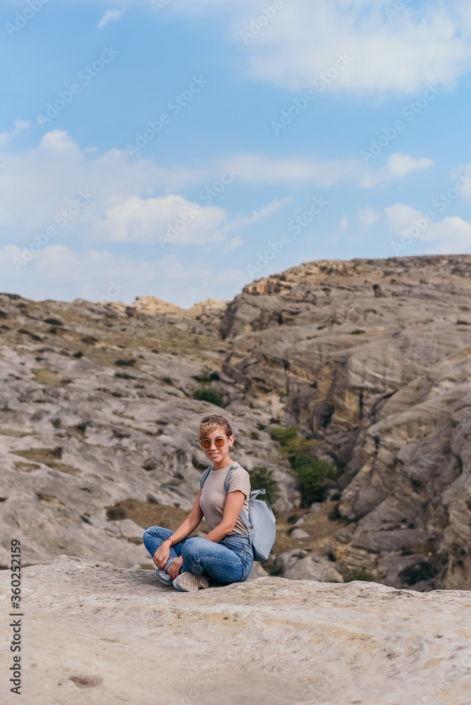 Fototapeta premium Young beautiful women on a camping trip, young woman hiking, woman hiking on a background of mountains