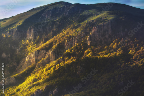 Mountain landscape at sunset with beautiful light on the forest on the mountain
