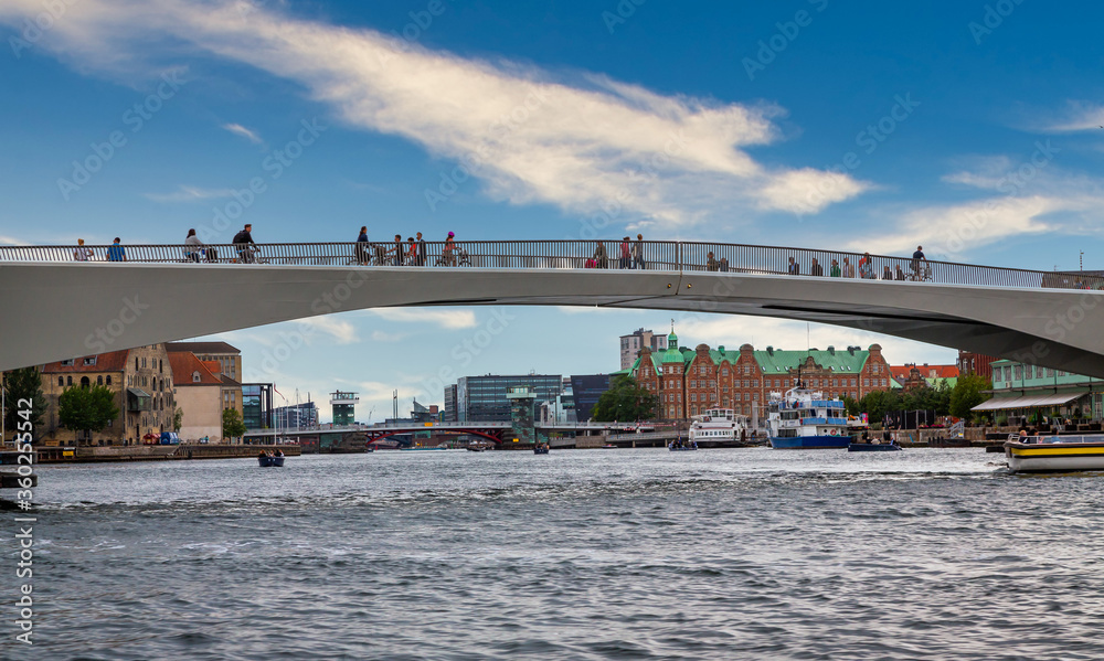 Photo of Copenhagen tourist landmark spot taken during a boat ride across the city canals, on a hot summer day with bright sky. Photo of Copenhagen tourist landmark spot taken during a boat ride across the city canals, on a hot summer day with bright sky.
