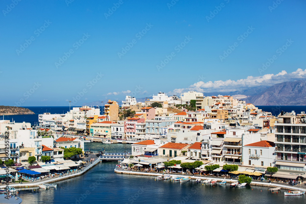 View of the houses, street and Lake Voulismeni in Agios Nikolaos, Crete island, Greece.