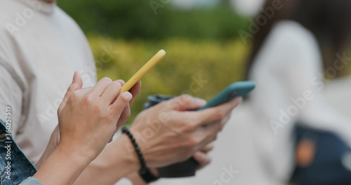 Friends use of cellphone at outdoor