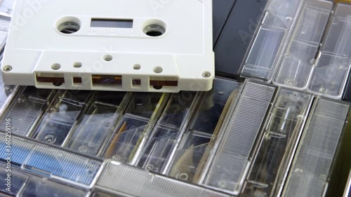 Audio cassette on a set of audio cassettes in cases. Turntable rotation
