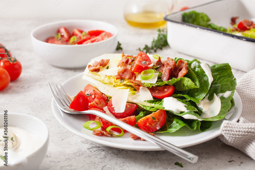 romaine lettuce topped with bacon tomato parmesan, sauce. healthy keto paleo diet lunch