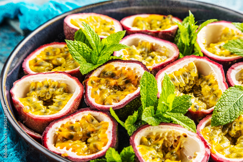 top view of fresh ripe delicious passion fruits with mint leaves top view of fresh ripe delicious passion fruits with mint leaves
