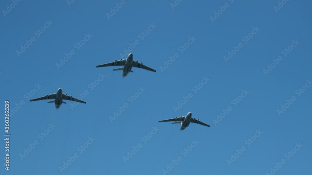 Column military warplanes flies over the ground in honor of the victory parade . Military planes in a beautiful blue sky. Air force parade. Column military warplanes flies over the ground in honor of the victory parade . Military planes in a beautiful blue sky. Air force parade.