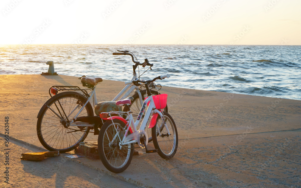 Bicycles on the beach with sunset background