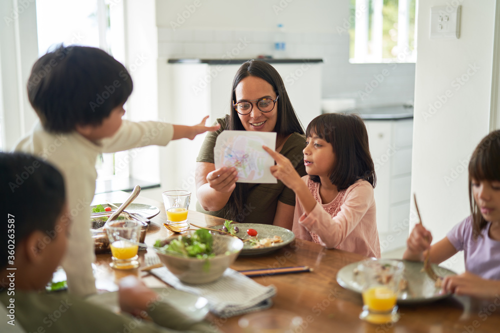 Mother and kids eating lunch at dining table Mother and kids eating lunch at dining table