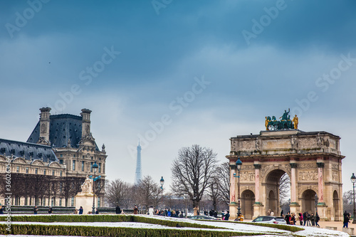 PARIS, FRANCE - MARCH, 2018: The Arch of Triumph, Louvre Museum and Eiffel Tower in a freezing winter day just before spring