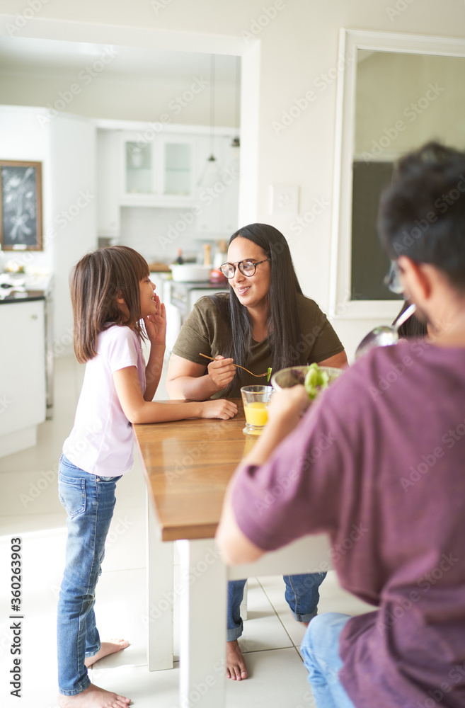 Mother and daughter talking at lunch table Mother and daughter talking at lunch table