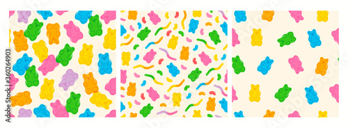 Colorful Fruity and tasty Sweets and Candies. Various Gummy and Jelly Worms, Beans, Bears. Hand drawn Vector Trendy illustration. Cartoon style. Set of three Seamless Patterns. Backgrounds, Wallpaper.