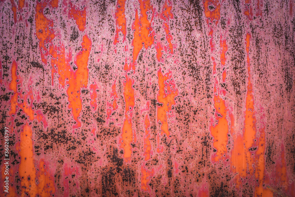 The old iron background is painted in red, pink, purple with rust and chips.