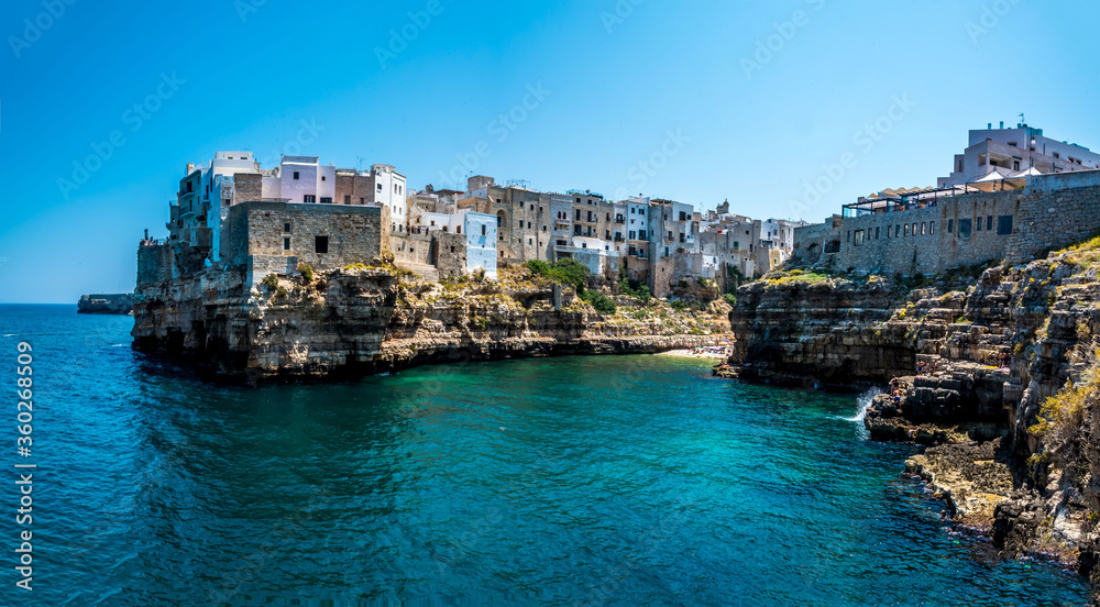 A rocky peninsula marks the entrance to the coastal inlet at Polignano a Mare, Puglia, Italy