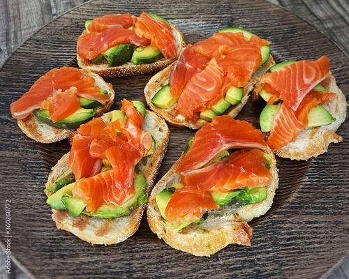 plate with six salmon avocado toasts