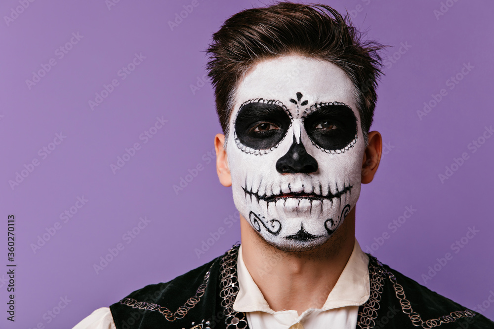 Close-up portrait of brunette man with traditional mexican halloween makeup.  Studio photo of scary caballero celebrating day of the dead. Stock Photo |  Adobe Stock