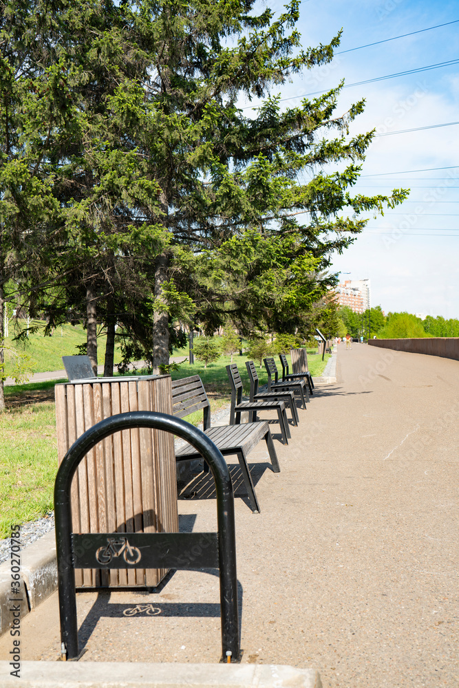 Benches along the alley in the park on the waterfront.