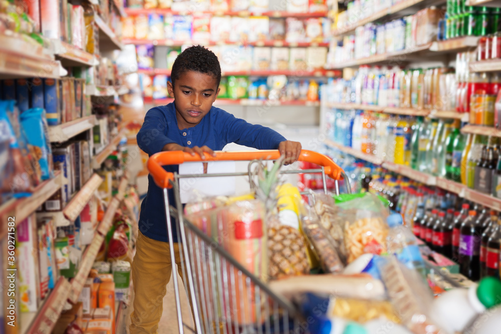 African boy shopping in grocery