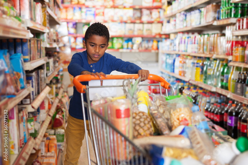 African boy shopping in grocery