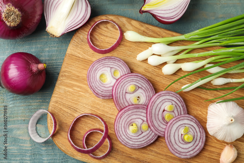 Flat lay composition with cut red onion on light blue wooden table Flat lay composition with cut red onion on light blue wooden table
