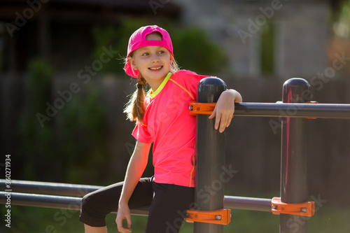 Little girl on a sports ground on the street leads a healthy lifestyle. In a healthy body healthy mind. Active lifestyle. Pretty young girl. Child for healthy lifestyle.